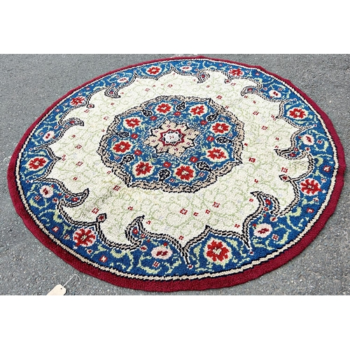 1696 - A circular hand knotted carpet of Middle Eastern design of a central floral medallion with a floral ... 