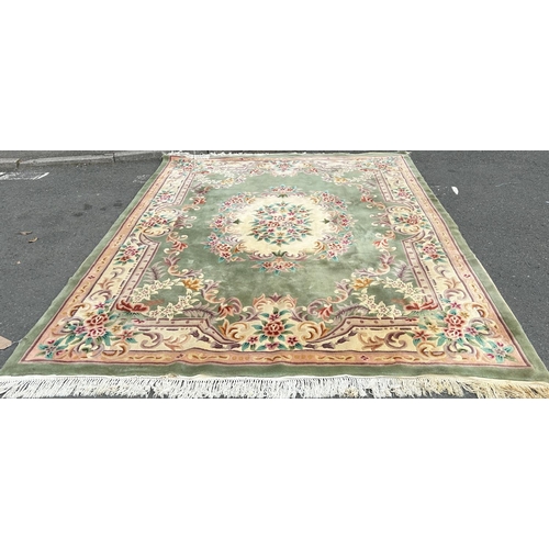 1698 - A large European style Chinese wool carpet bought by the vendor in Hong Kong 1973, a central spray o... 