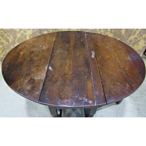 2198 - A Georgian oak oval drop leaf gateleg dining table with three quarter length end frieze drawer raise... 