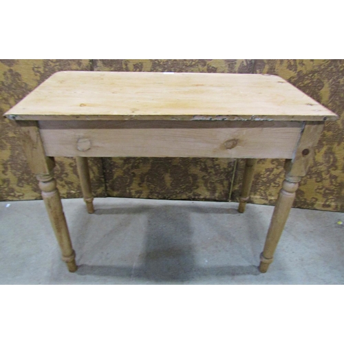 2203 - A 19th century stripped pine side table fitted with a shallow frieze drawer, raised on turned tapere... 