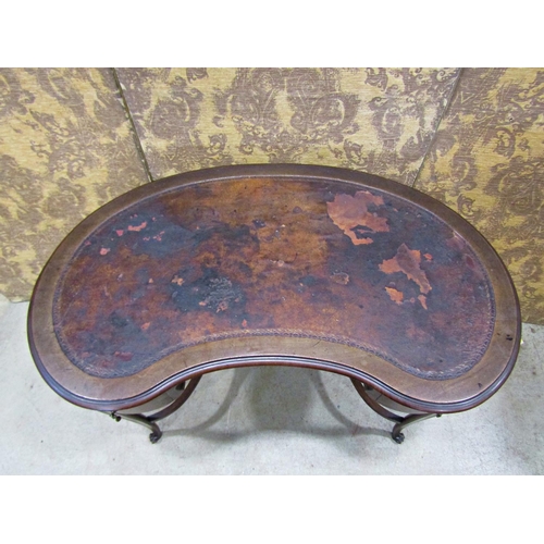 2209 - An Edwardian kidney shaped writing table with inset leather top over two small frieze drawers raised... 