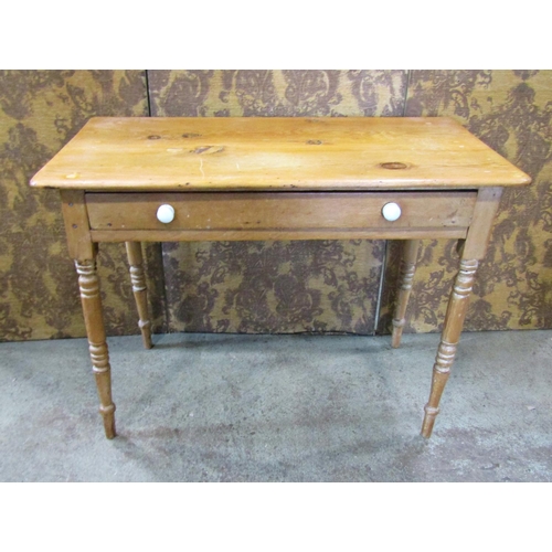 2211 - A Victorian stripped pine side table fitted with a slender frieze drawer raised on ring turned and t... 