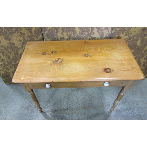 2211 - A Victorian stripped pine side table fitted with a slender frieze drawer raised on ring turned and t... 