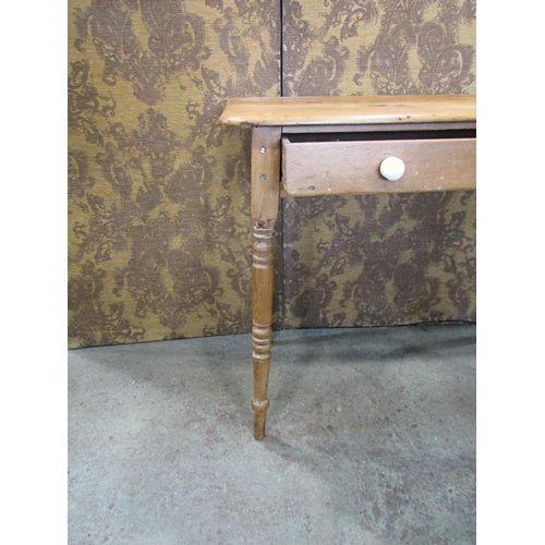 2211 - A Victorian stripped pine side table fitted with a slender frieze drawer raised on ring turned and t... 