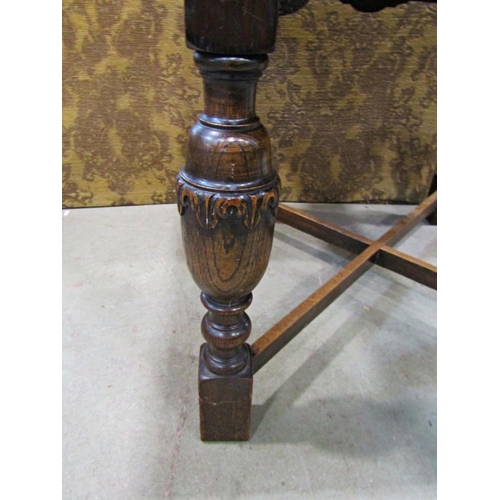 2214 - An oak plank top draw leaf dining table raised on baluster supports united by an X framed stretcher,... 