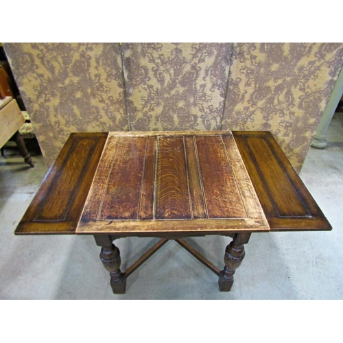 2214 - An oak plank top draw leaf dining table raised on baluster supports united by an X framed stretcher,... 