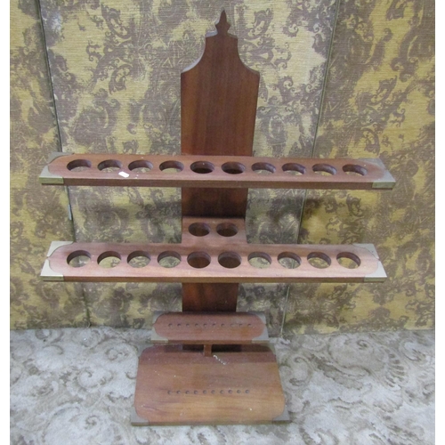 2216 - A hardwood stand with circular divisions and brass re-enforced corners, 80cm wide x 110cm high