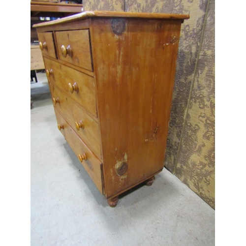 2220 - A Victorian stripped pine bedroom chest of three long and two short graduated drawers raised on turn... 