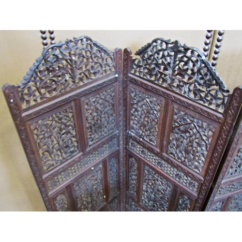 2222 - An eastern four fold screen with profusely carved decorative pierced foliate panels, 113cm high, tog... 