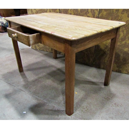 2223 - A stripped pine kitchen table of rectangular form with plank top over a frieze drawer raised on squa... 