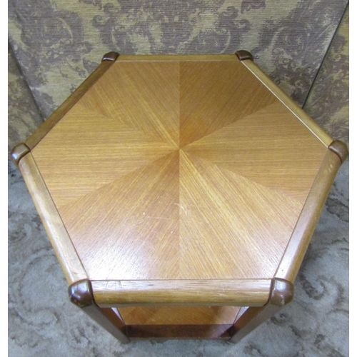 2225 - A Danish teak two tier occasional table of hexagonal form, raised on moulded supports, 50cm across x... 