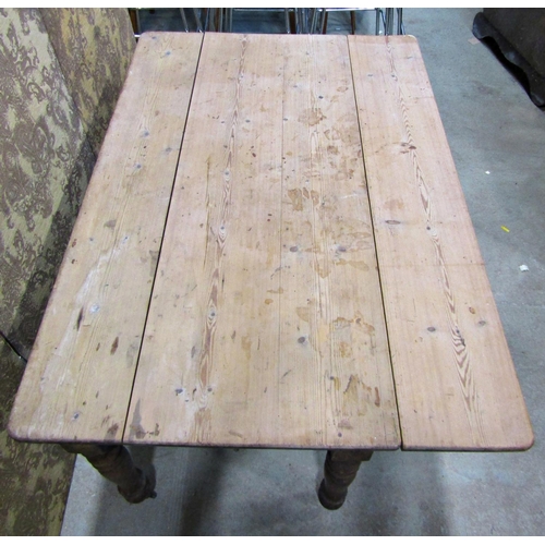 2232 - A Victorian pine drop leaf kitchen table on turned supports, 136cm long x 75cm wide when closed x 12... 