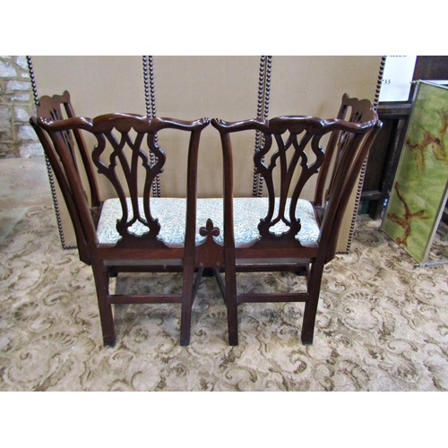 2243 - An antique mahogany seat formed from four mahogany chair backs with interlaced splats, raised on squ... 