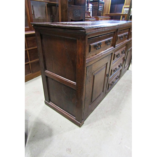 2244 - A Georgian oak dresser base enclosed by a T shaped arrangement of six drawers and two panelled cupbo... 