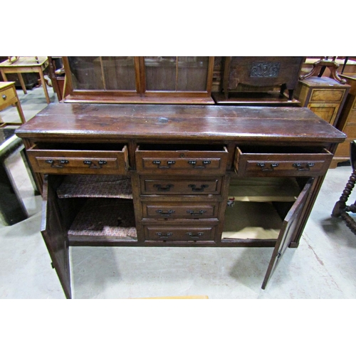 2244 - A Georgian oak dresser base enclosed by a T shaped arrangement of six drawers and two panelled cupbo... 