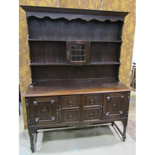 2248 - An Edwardian oak dresser in the Jacobean style, with two central drawers flanked by two cupboards wi... 