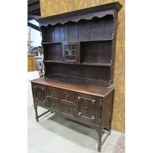 2248 - An Edwardian oak dresser in the Jacobean style, with two central drawers flanked by two cupboards wi... 