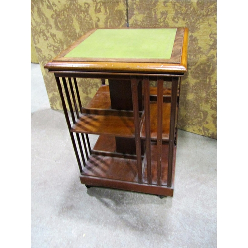 2249 - A late 19th century mahogany revolving two tier bookcase of square cut form with inset leather top, ... 