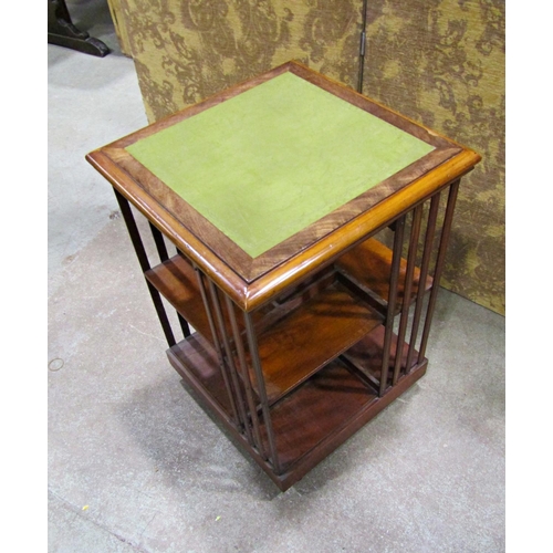 2249 - A late 19th century mahogany revolving two tier bookcase of square cut form with inset leather top, ... 