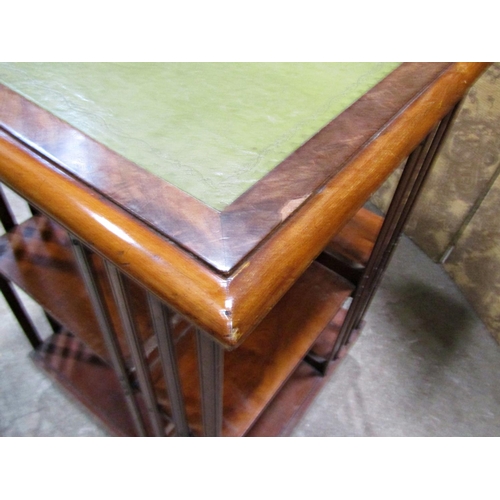 2249 - A late 19th century mahogany revolving two tier bookcase of square cut form with inset leather top, ... 