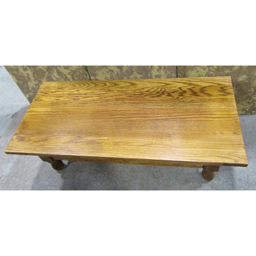 2251 - A pale oak occasional table on turned supports, 130cm long