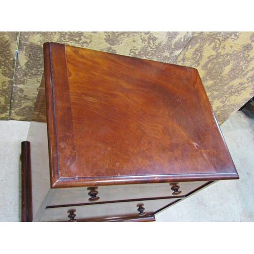 2254 - A Georgian mahogany commode with rising lid, the front elevation presented  as two drawers on bun su... 