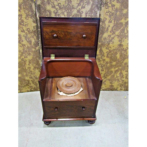 2254 - A Georgian mahogany commode with rising lid, the front elevation presented  as two drawers on bun su... 