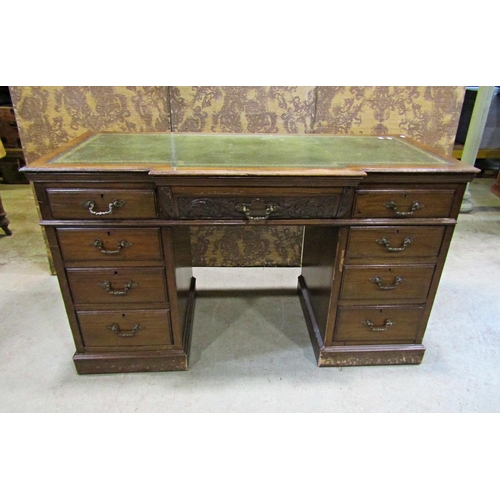 2256 - A late Victorian mahogany pedestal writing desk, the front elevation enclosing nine drawers beneath ... 