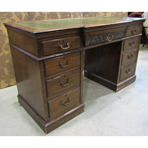 2256 - A late Victorian mahogany pedestal writing desk, the front elevation enclosing nine drawers beneath ... 