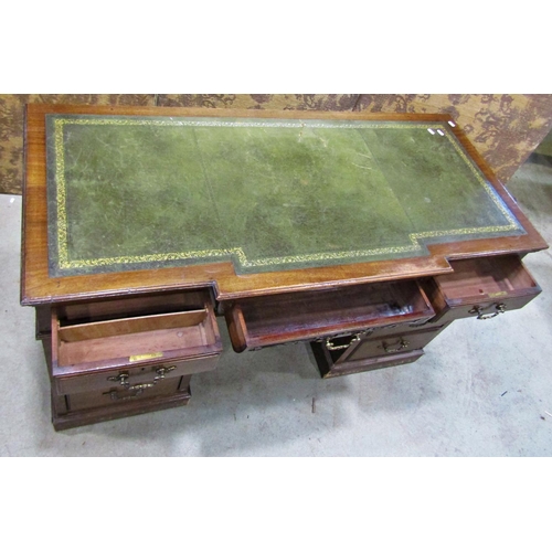 2256 - A late Victorian mahogany pedestal writing desk, the front elevation enclosing nine drawers beneath ... 