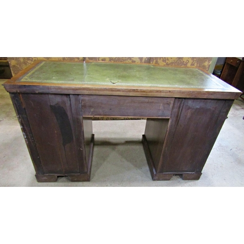 2256 - A late Victorian mahogany pedestal writing desk, the front elevation enclosing nine drawers beneath ... 