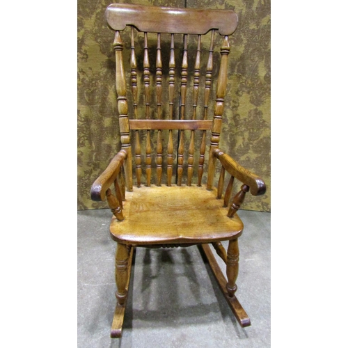 2257 - A Victorian Windsor spindle back rocking chair in mixed woods including ash and fruit woods