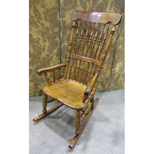 2257 - A Victorian Windsor spindle back rocking chair in mixed woods including ash and fruit woods