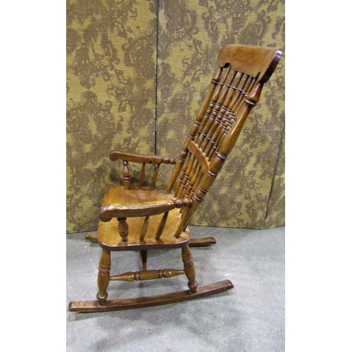 2257 - A Victorian Windsor spindle back rocking chair in mixed woods including ash and fruit woods