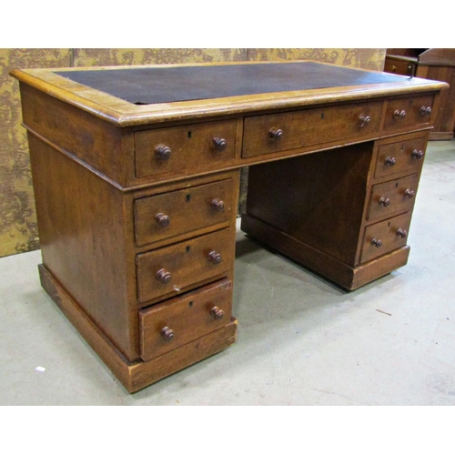 2259 - A Victorian oak pedestal writing desk of nine drawers with inset top, 122cm wide