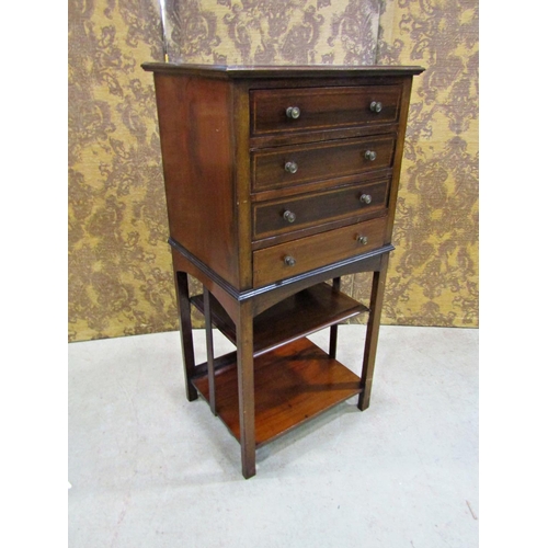 2260 - An inlaid Edwardian mahogany music cabinet of four drawers raised on an open framework, 50cm wide