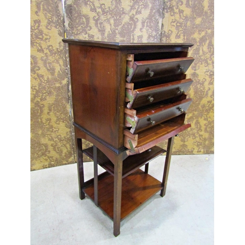 2260 - An inlaid Edwardian mahogany music cabinet of four drawers raised on an open framework, 50cm wide