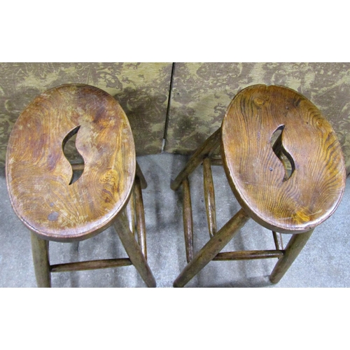 2261 - A pair of shop stools, with elm seats on turned beechwood supports, 61cm high