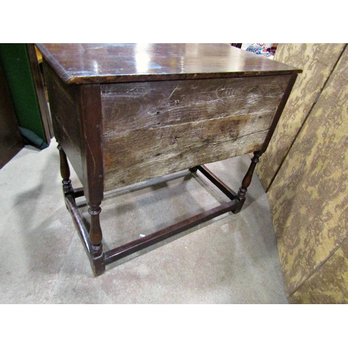 2265 - An old English oak side table in a Jacobean style the front elevation enclosed by two cupboards (dis... 