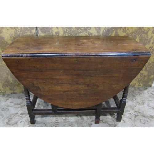 2271 - A Georgian fruitwood gateleg dining table on turned supports enclosing a frieze drawer on shaped fee... 