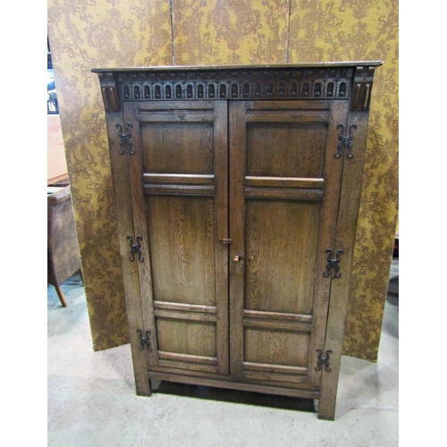 2300 - A good quality old English style carved and panelled hanging robe with hand wrought iron hinges, 121... 