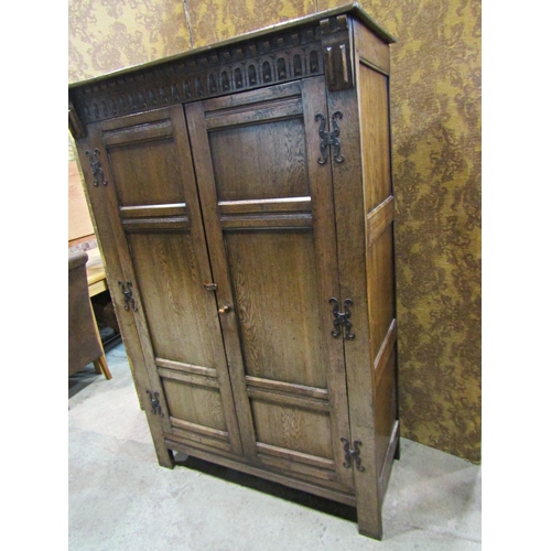 2300 - A good quality old English style carved and panelled hanging robe with hand wrought iron hinges, 121... 