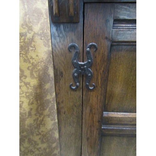 2300 - A good quality old English style carved and panelled hanging robe with hand wrought iron hinges, 121... 