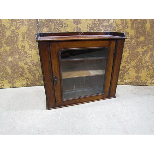 2303 - A Victorian mahogany hanging wall cupboard with glazed panelled door, 66 cm wide