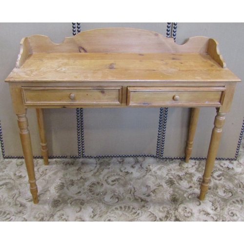 2314 - A waxed pine side table with two frieze drawers, three quarter gallery and raised on turned supports... 