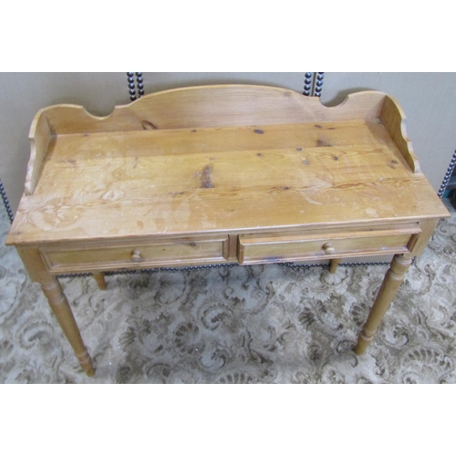 2314 - A waxed pine side table with two frieze drawers, three quarter gallery and raised on turned supports... 