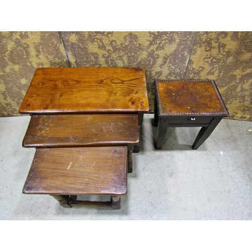 2320 - A nest of three old English oak occasional tables on turned supports 61cm wide and smaller, together... 