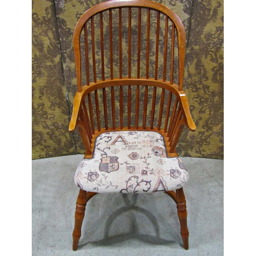 2321 - A Windsor style comb back elbow chair with upholstered seat and crinoline stretcher