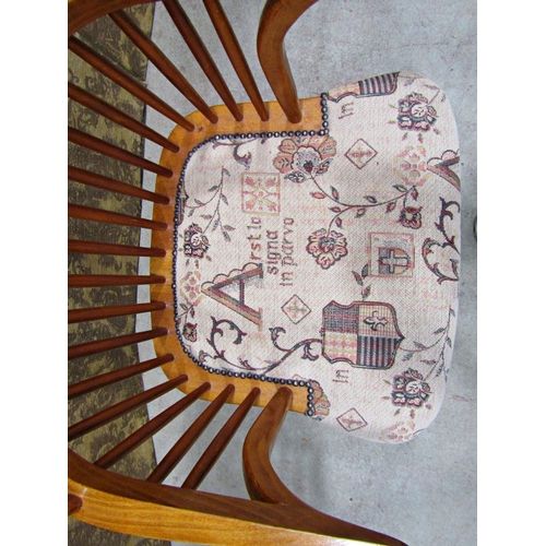 2321 - A Windsor style comb back elbow chair with upholstered seat and crinoline stretcher