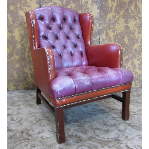 2322 - A Georgian style wing chair with two tone leather upholstery finish, the framework with square cut s... 